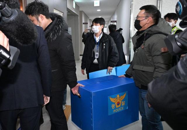 Police officers leave Muan International Airport after a raid in South Jeolla Province on Jan 2 2025 Yonhap