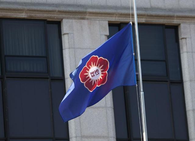 A flag is at half-mast at the Constitutional Court of Korea on Jan 2 2024 in tribute to the victims of the fatal crash of a Jeju Air flight last Sunday Yonhap