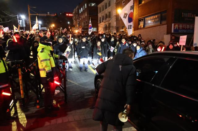 Protesters check passengers in vehicles moving toward the presidential residence in Hannam-dong Seoul Jan 2 2024 AJP Han Jun-gu