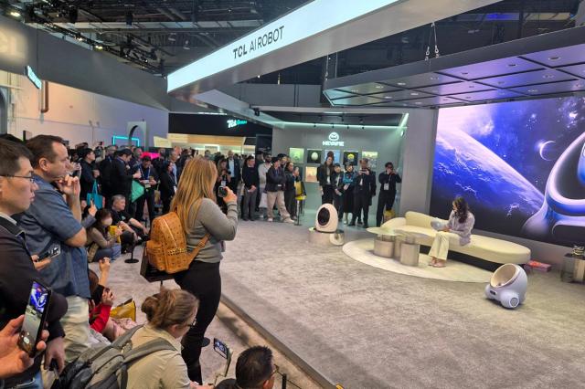 Visitors watch a demonstration of TCLs AI robot Amy at CES 2025 Las Vegas Convention Center Yonhap