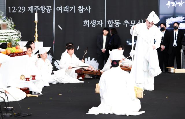 A traditional shamanic rite is performed during a joint memorial service for the victims of the Dec 29 Jeju Air crash held at Muan International Airport in Muan on Jan 18 2025 Yonhap