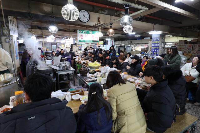 Visitors enjoy the markets famous kalguksu noddle soup at Kyungdong Market in Seoul AJP Han Jun-gu