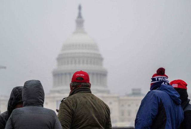 Supporters of incoming US President Donald Trump line up on the National Mall near the US Capitol for a MAGA victory rally at Capital One Arena in Washington DC on Jan 19 2025 a day ahead of Trumps inauguration AP-Yonhap