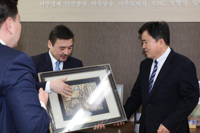 Kwak Young-kil chairman of Aju News Corporation receives a gift from Ambassador of the Republic of Kazakhstan Nurgali AArystanov at the Aju News Corporation office in Seoul on Jan 21 2025 AJP Han Jun-gu