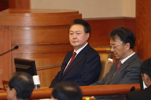 President Yoon Suk Yeol left attends his impeachment trial at the Constitutional Court in Seoul on Jan 21 2025 Yonhap