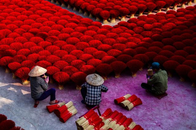 Workers arrange incense sticks to be dried in a courtyard ahead of the Lunar New Year celebrations in Quang Phu Cau village outside Hanoi Viet Nam Jan 20 2025 Reuters-Yonhap