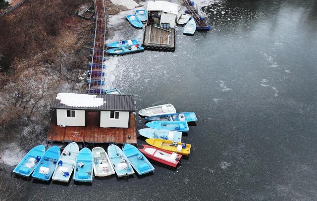 Fishing boats surrounded by frozen surface of Geumgwang Lake in Anseong Gyeonggi Province Yonhap