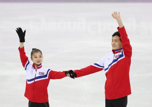 North Koreas Rim Tae-ok and Kim Ju-sik are seen greeting each other before practice during the pair free skating event at the 2018 PyeongChang Winter Olympics Yonhap
