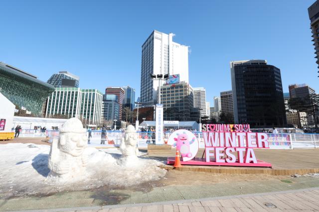 Ice sculptures of Dolhareubang stone grandfather statue in front of Seoul Plaza ice skating rink AJP Han Jun-gu