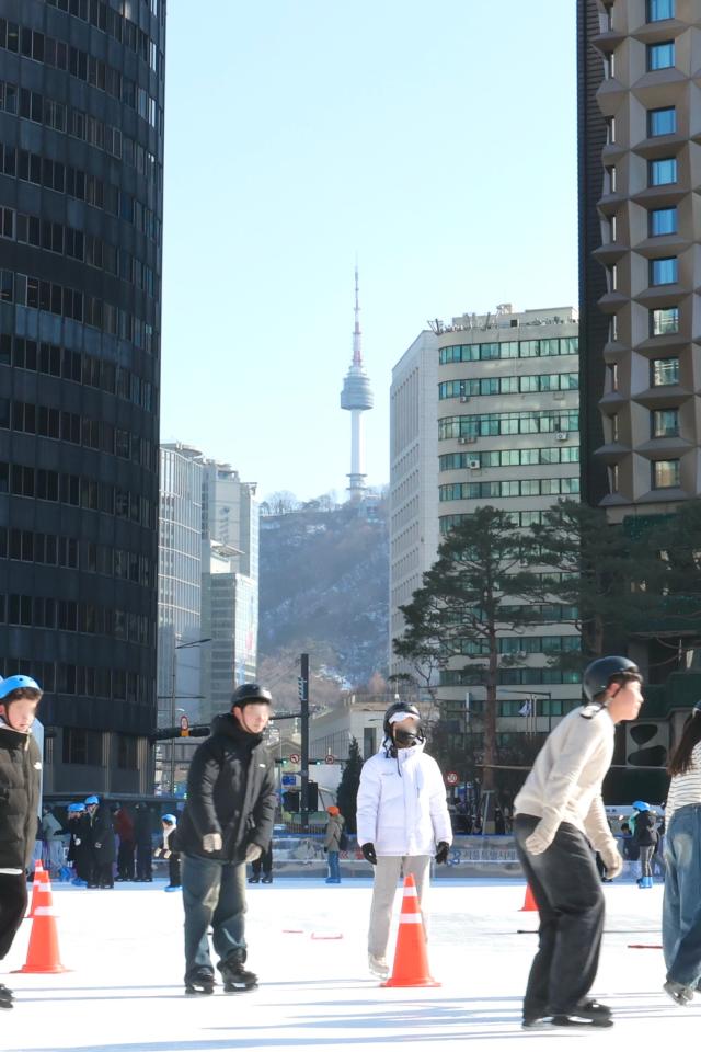 N Seoul Tower seen behind Seoul Plaza ice skating rink AJP Han Jun-gu