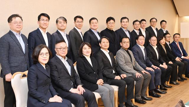 Acting President Choi Sang-mok middle grey suit poses for a photo with the Korea Chamber of Commerce and Industry KCCI delegation led by SK Group Chairman Chey Tae-won right of Choi Feb 16 2025 Courtesy of the Ministry of Economy and Finance