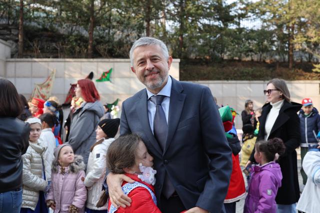 Russian Ambassador to South Korea Georgy Zinoviev poses for a photograph with a student from the Russian school in Seoul at an event designed to celebrate the traditional Russian spring festival Meslenitsa at the Russian Embassy in the Republic of Korea on February 28 AJP Han Jun-gu