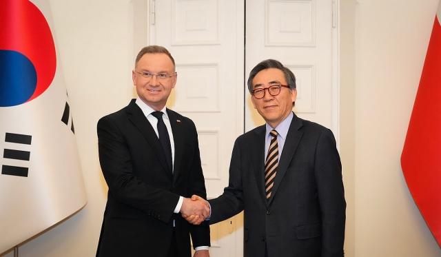 Polish President Andrzej Duda shakes hands with South Korean Foreign Minister Cho Tae-yul during their meeting in Warsaw Poland on Mar 6 2025