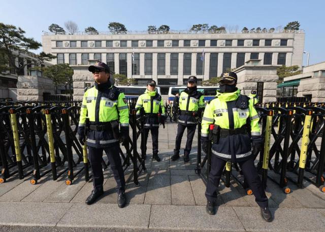 Police officers are seen outside the Constitutional Court of Korea in central Seoul on March 9 2025 Yonhap