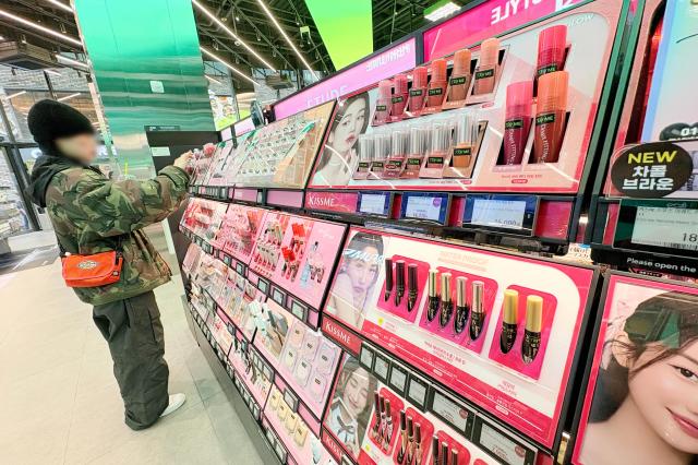 A customer browses cosmetics at a CJ Olive Young shop in Seoul March 12 2025 Yonhap