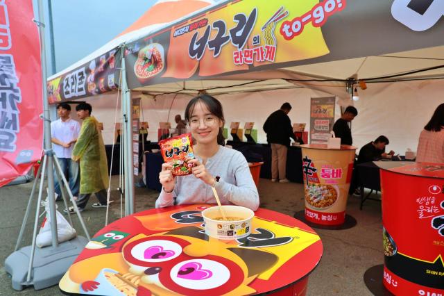 한 관람객이 36일 전남 완도군 완도해변공원에서 열린 2025 완도 장보고수산물축제 행사장 내 너구리 라면가게에서 농심 너구리를 즐기고 있다 사진농심