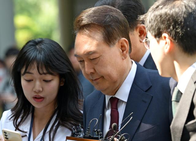 Ex-president declines to comment at first public court appearance