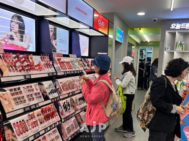 Customers browse an products at Olive Young AJP Candice Kim