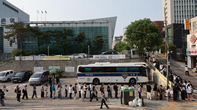 People wait in line to cast their ballots at a polling station in Seoul on May 30 2025 Yonhap