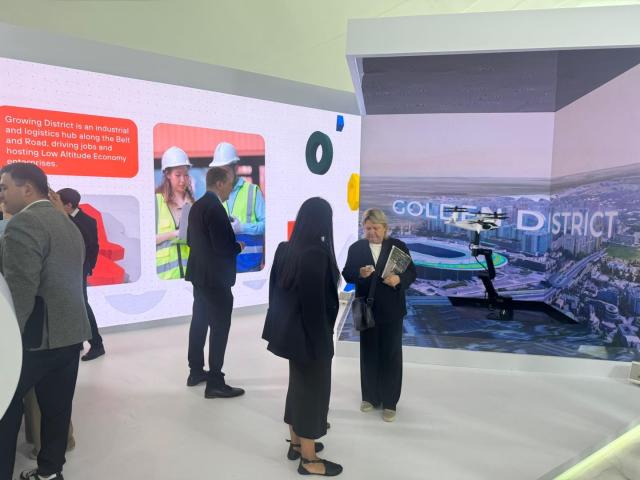 Participants of the Astana International Forum visit an exhibition booth introducing the Alatau New City project at the annual Astana International Forum AIF in Kazakhstan on May 30 2025