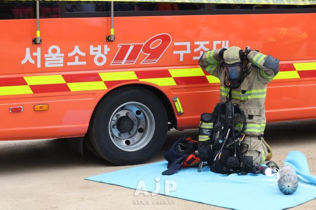 A firefighter puts on equipment at the Korean Buddhist history and culture memorial hall at Jogyesa temple in Jongno Seoul on June 10 2025 AJP Han Jun-gu