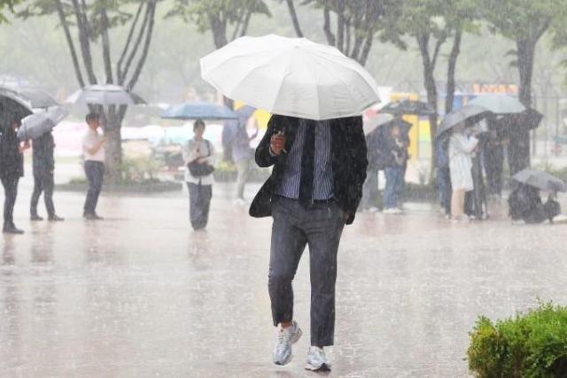 서울 광장에서 우산을 쓴 시민들이 발걸음을 재촉하고 있다 서잔연합뉴스