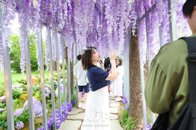 A visitor poses for a photo at Seoul international garden show 2025 Boramae Park Seoul Jun 13 2025 AJP Han Jun-gu