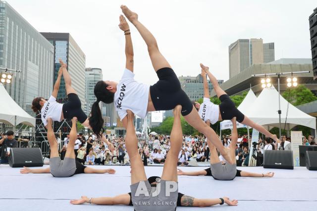 A yoga performance takes place during the 11th International Day of Yoga event at Gwanghwamun Square in central Seoul on June 21 2025 AJP Han Jun-gu