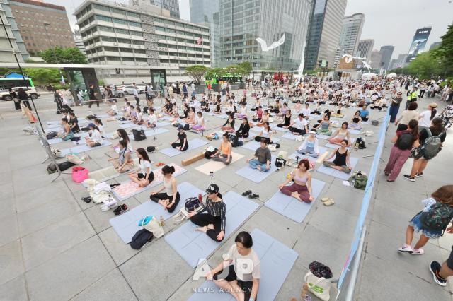 Participants practice yoga during the 11th International Day of Yoga event held at Gwanghwamun Square in central Seoul on June 21 2025 AJP Han Jun-gu