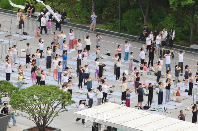 Participants practice yoga during the 11th International Day of Yoga event held at Gwanghwamun Square in central Seoul on June 21 2025 AJP Han Jun-gu