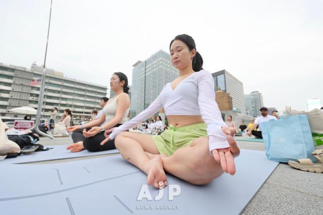 Participants practice yoga during the 11th International Day of Yoga event held at Gwanghwamun Square in central Seoul on June 21 2025 AJP Han Jun-gu