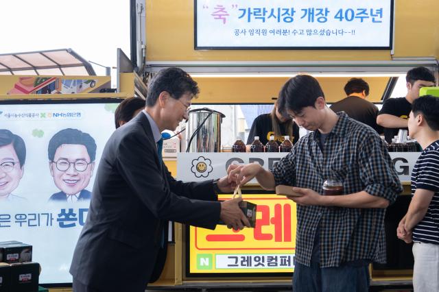 NH농협은행 강태영 은행장이 간식행사에서 쌀 소비 촉진 홍보활동의 일환으로 농협 즉석밥을 나누어 주고 있다 사진농협은행

