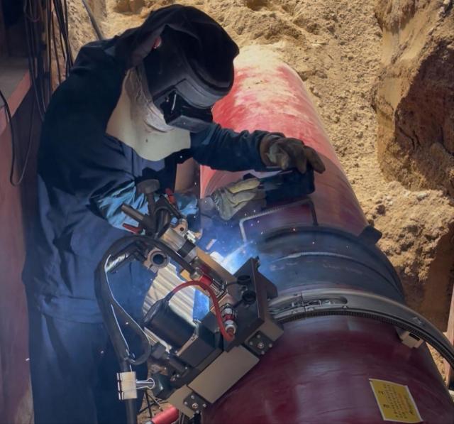 An engineer welding underground LNG pipes Courtesy of KOGAS