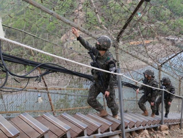 Soldiers of the Army’s 7th Infantry Division patrolling the fence line at a GOP post in Hwacheon County Gangwon Province  Courtesy of the Republic of Korea Army