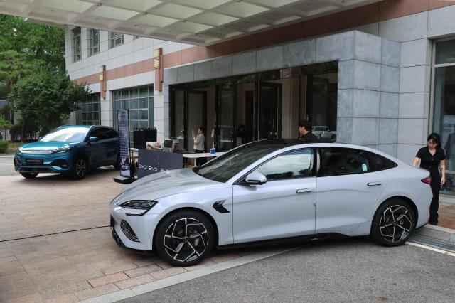 Invited guests examine BYDs Atto 3 and Seal electric vehicles at an open day event held at the Chinese Embassy in Jung-gu Seoul on July 22 2025 Yonhap