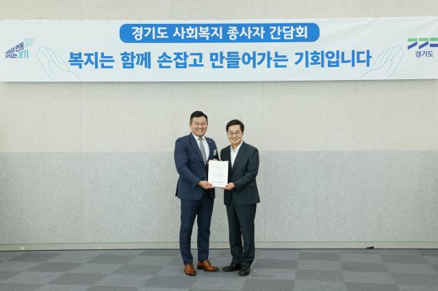 8일 오전 경기도 단원홀에서 김동연 경기도지사에게 박찬수 경기도사회복지사협회장가 사회복지종사자 처우개선비 인상 및 지원대상 확대 관련 서명부 전달하고 있다 사진경기도