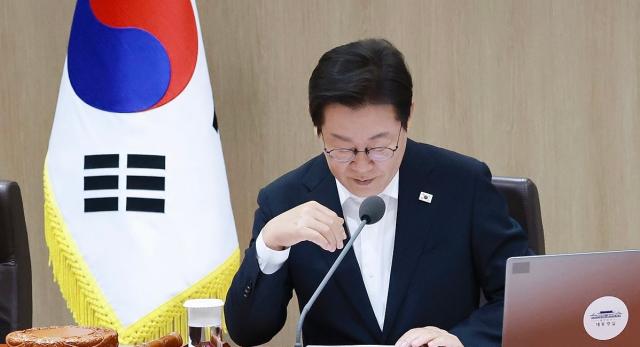 President Lee Jae-myung reviews documents during a Cabinet meeting at the presidential office in Yongsan Seoul on Aug 11 2025 Yonhap