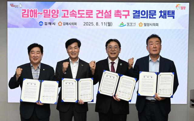 경남 밀양시와 김해시가 11일 김해시청 정책회의실에서‘김해밀양 고속도로 건설사업’ 예비타당성 조사 통과와 조기 착공을 촉구하는 공동 결의문에 서명한 뒤 기념 촬영을 하고 있다 사진밀양시