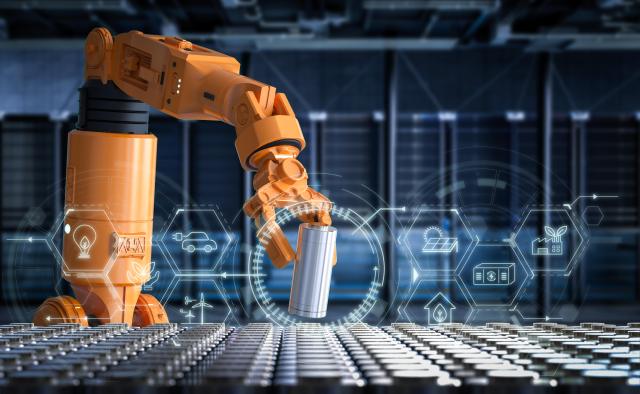 A robot arm holding a cylindrical battery Getty Images Bank