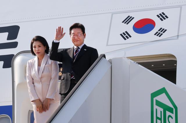 한일 정상회담을 마친 이재명 대통령과 부인 김혜경 여사가 24일 일본 도쿄 하네다공항에서 도널드 트럼프 미국 대통령과의 한미 정상회담을 위해 워싱턴DC로 향하며 공군1호기에 올라 인사하고 있다사진도쿄연합뉴스