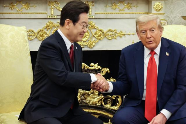 President Lee Jae Myung left shakes hands with US President Donald Trump during a summit at the Oval Office in Washington DC Aug 25 2025 Yonhap