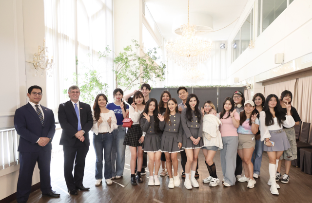 BlingOne pose with Peruvian Ambassador second from left and their fans