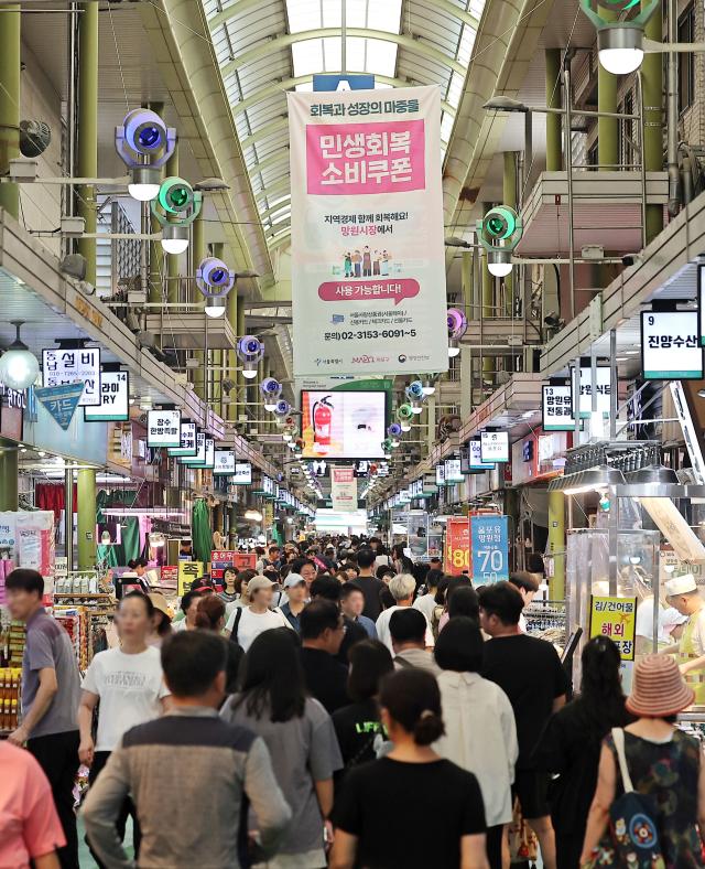 정부의 민생 회복 소비쿠폰 발행 한 달이 지난 가운데 지난 24일 서울 마포구 망원시장에 쿠폰 홍보 안내문이 부착되어 있다 연합뉴스