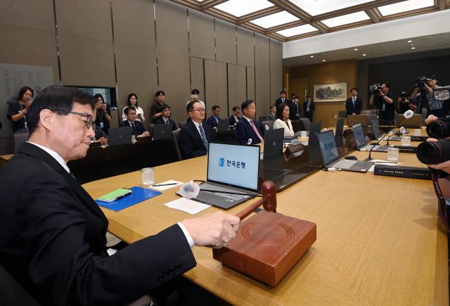 Bank of Korea Governor Rhee Chang-yong hits the gavel during a monetary policy committee meeting held at the BOK headquarters in Seoul Aug 28 2025 Joint Press Corps