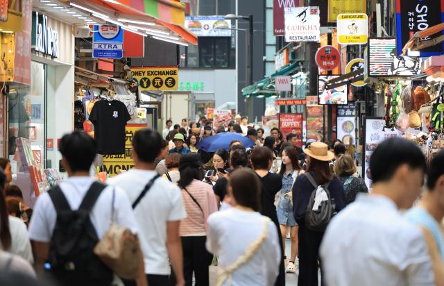 Tourists stroll at Seouls shopping district of Myeong-dong in the capital on Aug 15 2025 Yonhap