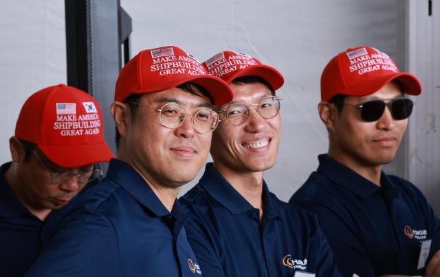 Officials participating in the naming ceremony of the State of Marine wear red hats written with the slogan Make American Shipbuilding Great Again Aug 26 2025 Yonhap