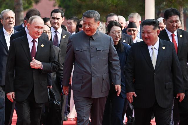 Russian President Vladimir Putin left Chinese President Xi Jinping center and North Korean leader Kim Jong-un right appear together before the military parade in Beijing TASS-Yonhap