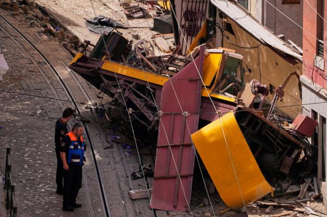 Police officers inspect a site where a tourist funicular derailed and crashed in Lisbon Portugal on Sept 4 2025 AP-Yonhap