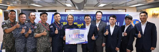 해군 제1함대사령부 동해군항 대구함에서 진행한 해군1함대-신한은행 신한 더 FIRST 업무협약 체결식에서 양 기관 관계자들이 발전기금 전달 후 기념사진을 촬영하고 있다 사진해군1함대