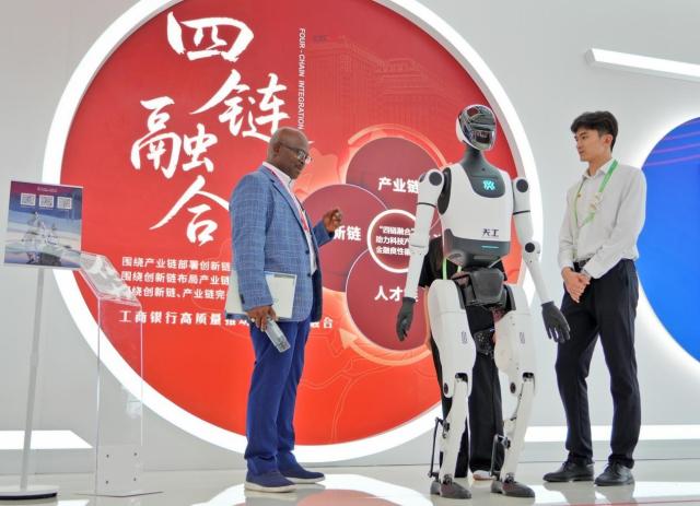 A visitor learns about a humanoid robot at the third China International Supply Chain Expo CISCE in Beijing July 16 2025 Peoples Daily